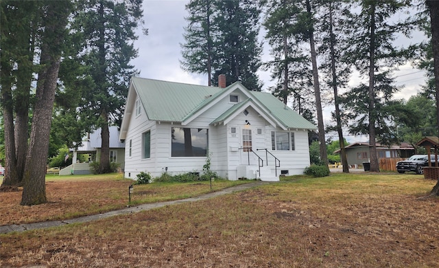 bungalow-style home featuring a front yard