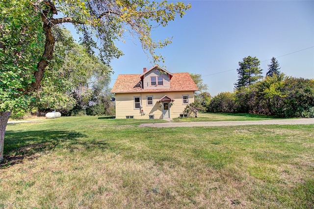 view of front facade featuring a front yard and a chimney