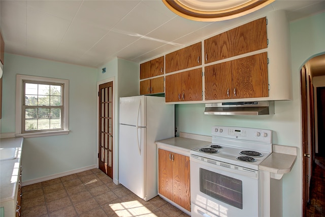 kitchen with white appliances and light tile patterned floors