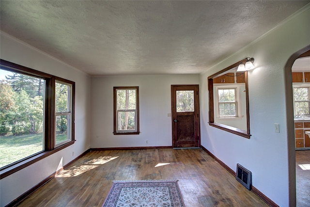 foyer entrance featuring a textured ceiling and hardwood / wood-style floors