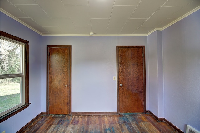 unfurnished room featuring crown molding and dark hardwood / wood-style floors