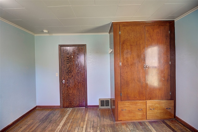 unfurnished bedroom featuring ornamental molding and hardwood / wood-style flooring