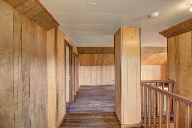 hall featuring wood walls and dark hardwood / wood-style floors