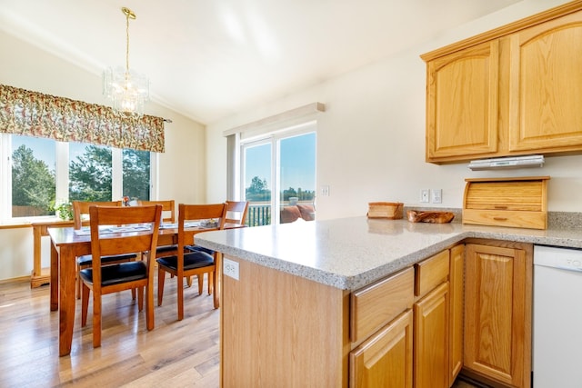 kitchen featuring light wood-type flooring, plenty of natural light, lofted ceiling, and white dishwasher