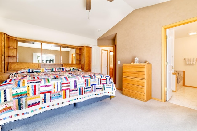 carpeted bedroom featuring connected bathroom and lofted ceiling