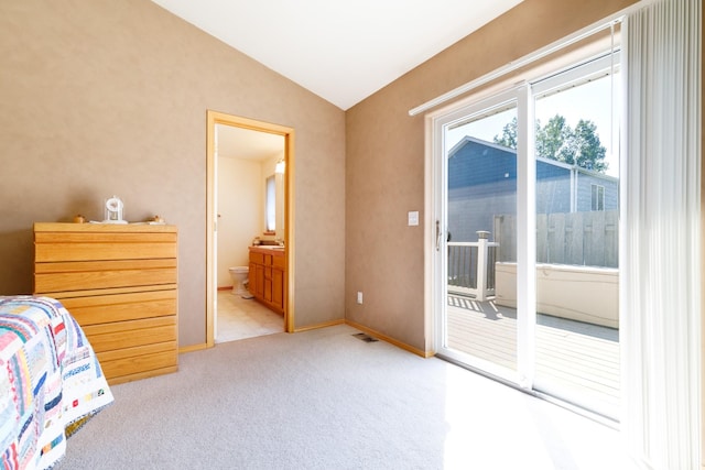 bedroom featuring visible vents, connected bathroom, vaulted ceiling, light carpet, and access to outside