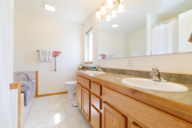 full bath with double vanity, toilet, baseboards, and a sink