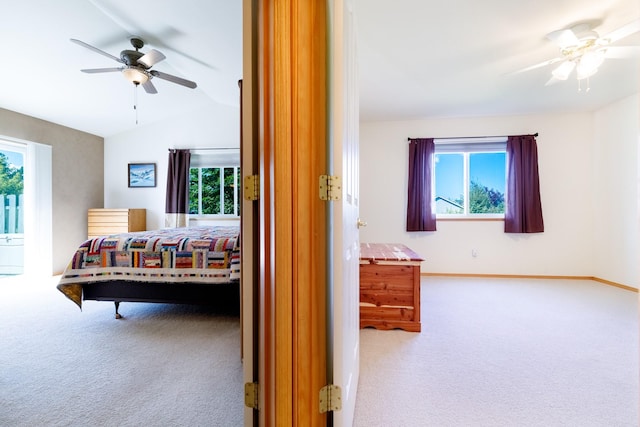 carpeted bedroom featuring baseboards, a ceiling fan, and vaulted ceiling