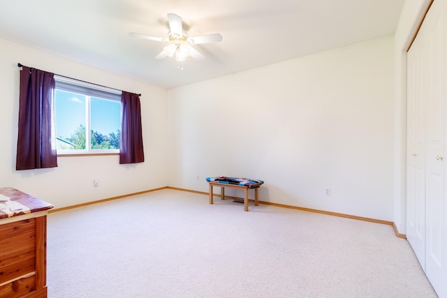 unfurnished bedroom with light colored carpet, a closet, and baseboards