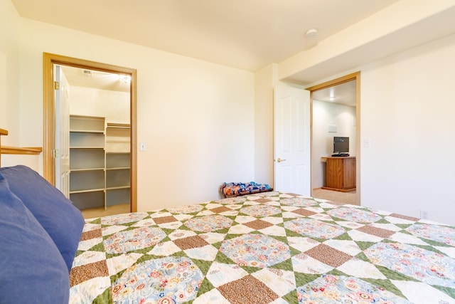 bedroom featuring carpet flooring, a closet, and a spacious closet