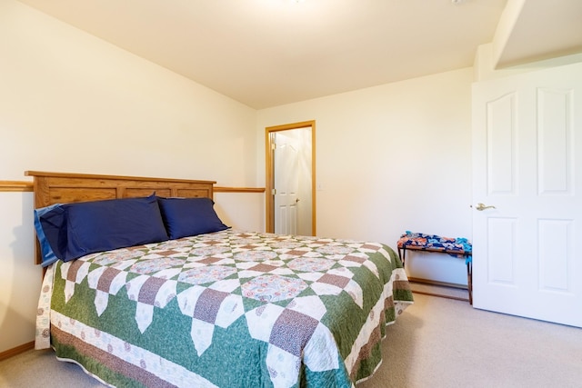 bedroom featuring baseboards, lofted ceiling, and carpet flooring