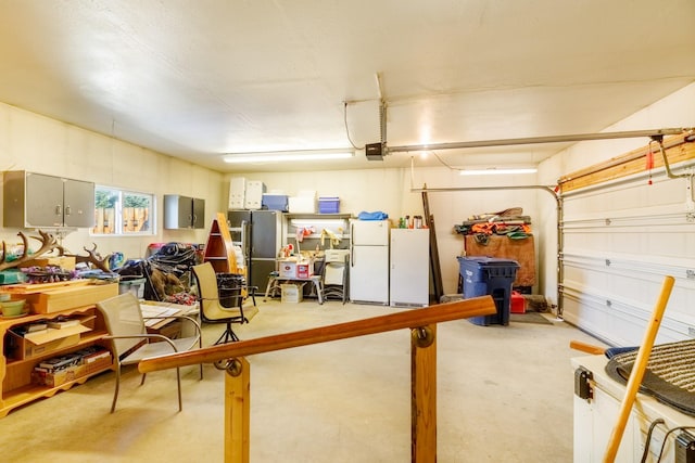 garage with a garage door opener and freestanding refrigerator