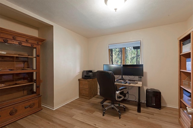 office featuring light wood-type flooring and baseboards