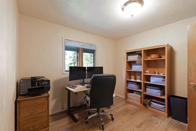 office space featuring light wood-style floors and baseboards