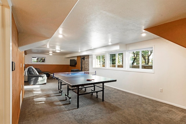 rec room featuring carpet floors, a wealth of natural light, a textured ceiling, and baseboards