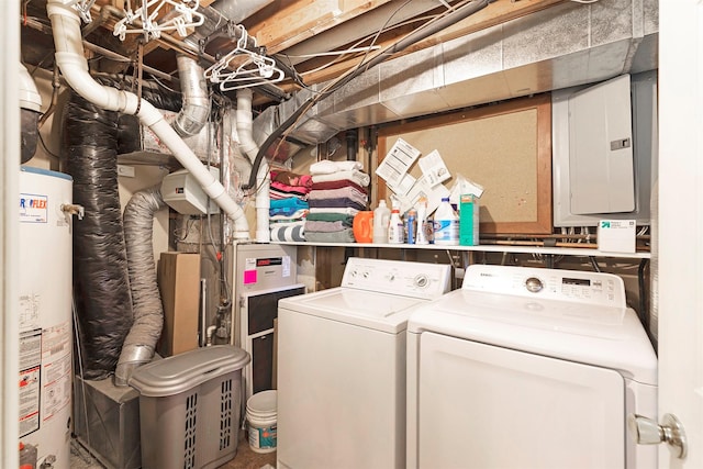 clothes washing area featuring electric panel, laundry area, water heater, and independent washer and dryer