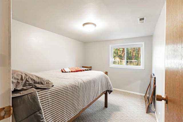 carpeted bedroom featuring visible vents and baseboards