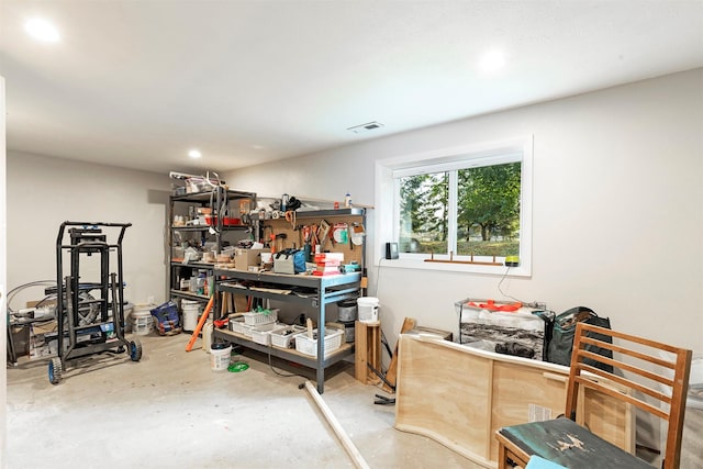 interior space with concrete floors, visible vents, and a workshop area