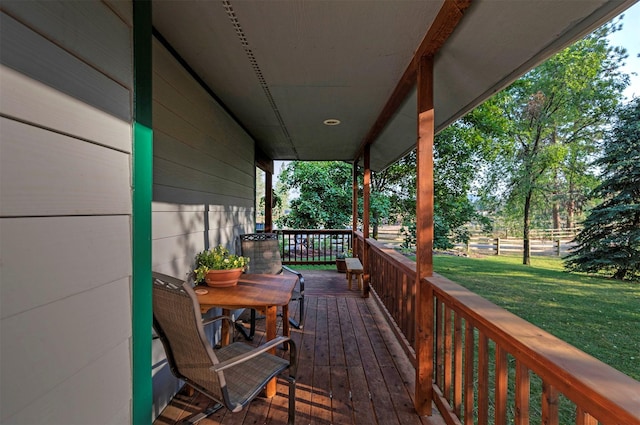 wooden terrace featuring a yard