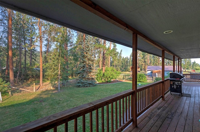 deck with a lawn and area for grilling