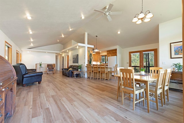 dining room featuring high vaulted ceiling, light wood-type flooring, and a ceiling fan