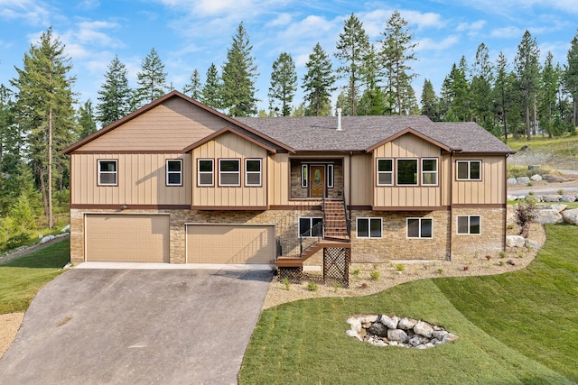 view of front of home with a garage and a front lawn