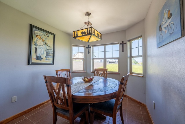 dining space with dark tile patterned flooring