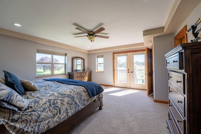 bedroom with multiple windows, french doors, access to outside, and light colored carpet