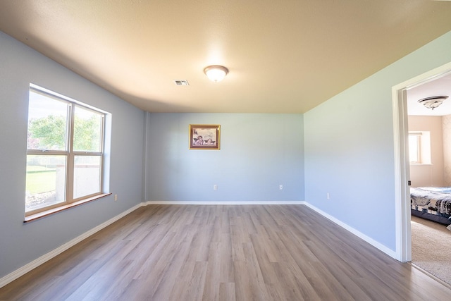 spare room with light hardwood / wood-style flooring