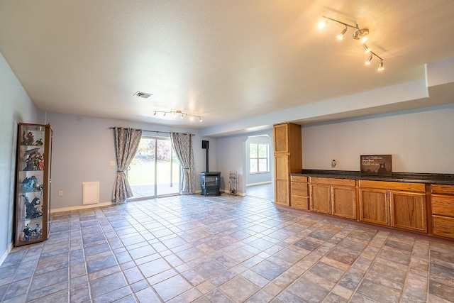 unfurnished living room with a wood stove