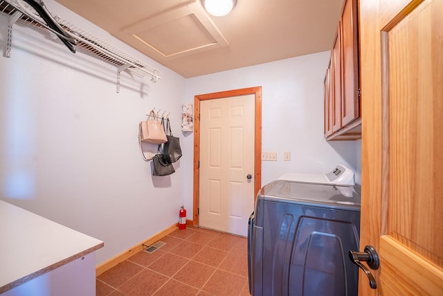 laundry area featuring cabinets, separate washer and dryer, and light tile patterned flooring