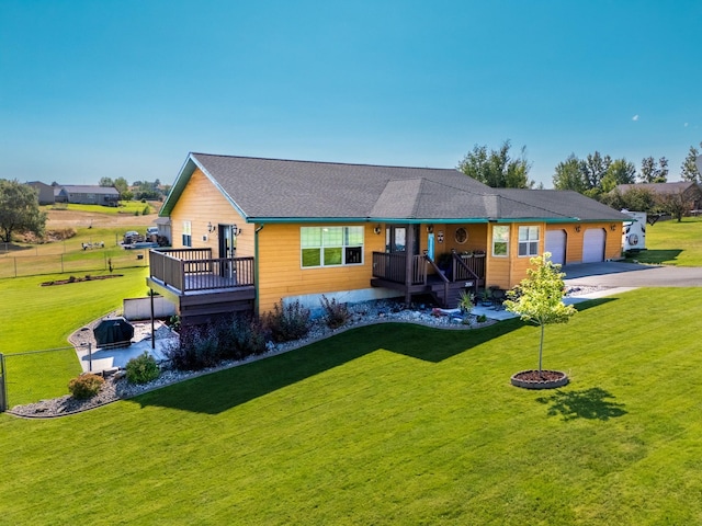 single story home with a garage, covered porch, a wooden deck, and a front yard