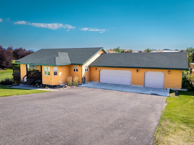 single story home with a front lawn and a garage