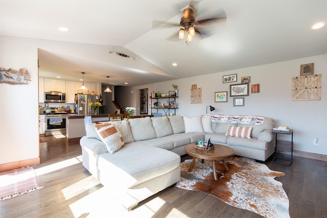 living room featuring hardwood / wood-style flooring, lofted ceiling, and ceiling fan