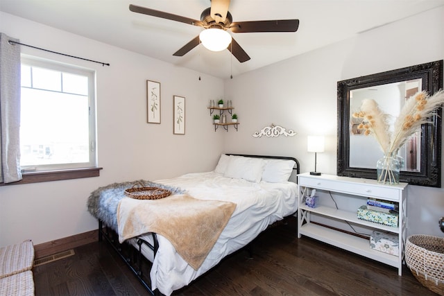 bedroom with ceiling fan, hardwood / wood-style flooring, and multiple windows