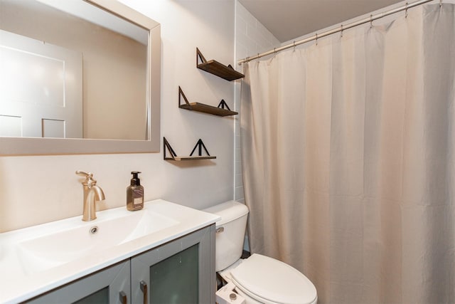 bathroom featuring toilet and vanity