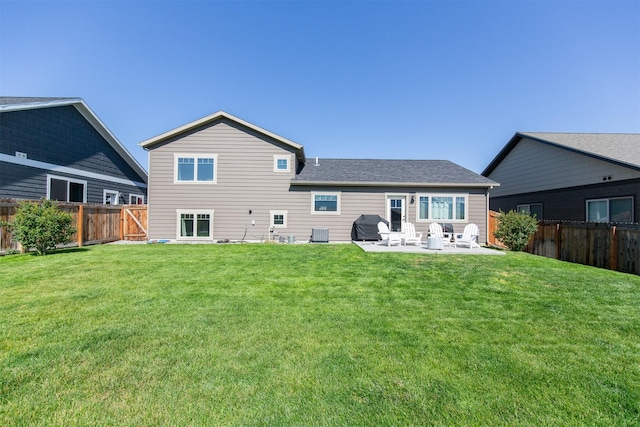 rear view of property with a lawn and a patio area