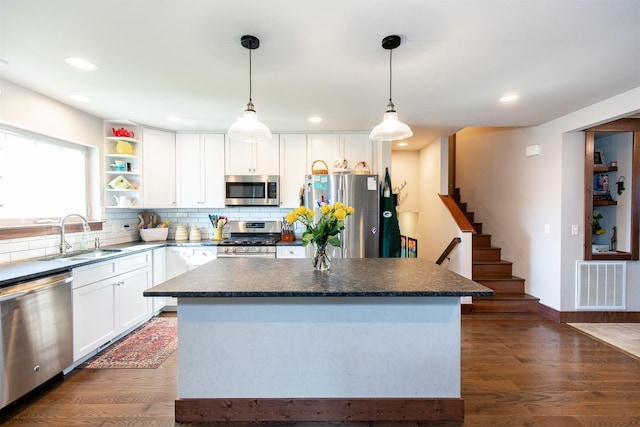 kitchen with white cabinetry, sink, stainless steel appliances, and dark wood-type flooring