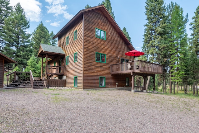 view of side of home featuring a wooden deck