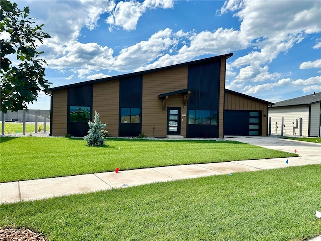 modern home featuring a front yard and a garage