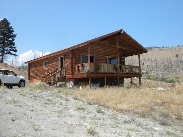 cabin featuring log siding