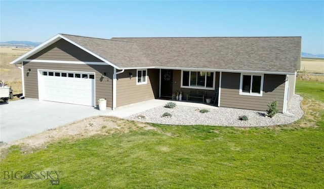 ranch-style house featuring a front lawn, roof with shingles, concrete driveway, and an attached garage