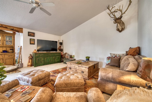 living area with lofted ceiling, a textured ceiling, ceiling fan, and carpet flooring