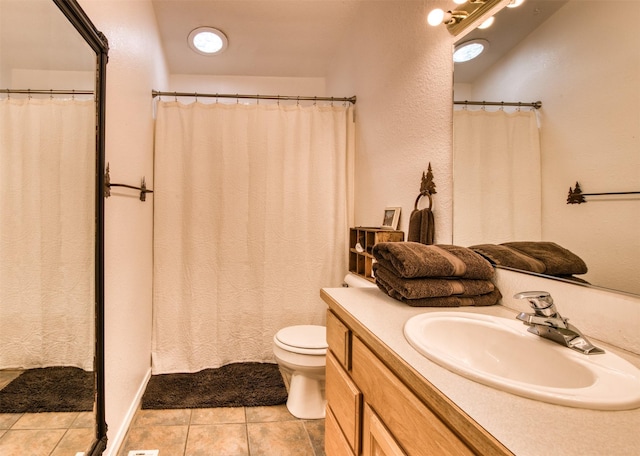 full bathroom featuring tile patterned flooring, toilet, and vanity