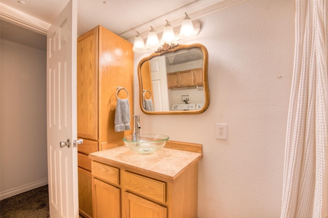 bathroom featuring vanity, baseboards, and ornamental molding