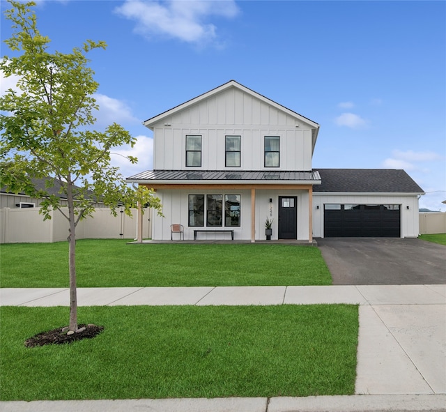 modern inspired farmhouse with a garage and a front lawn