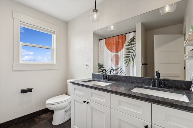 bathroom with tile patterned flooring, toilet, and vanity