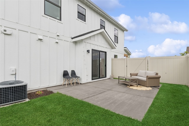 rear view of house with a patio, central air condition unit, an outdoor hangout area, and a lawn