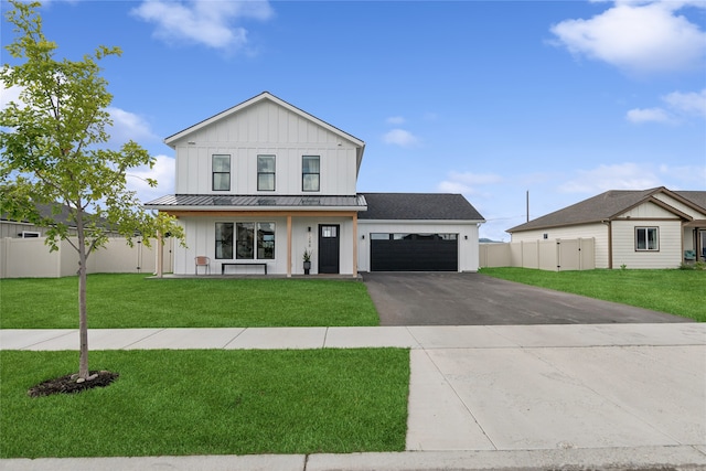 modern farmhouse featuring a garage and a front lawn