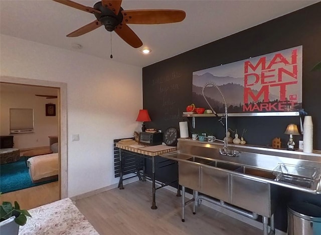 bar with wood-type flooring and ceiling fan